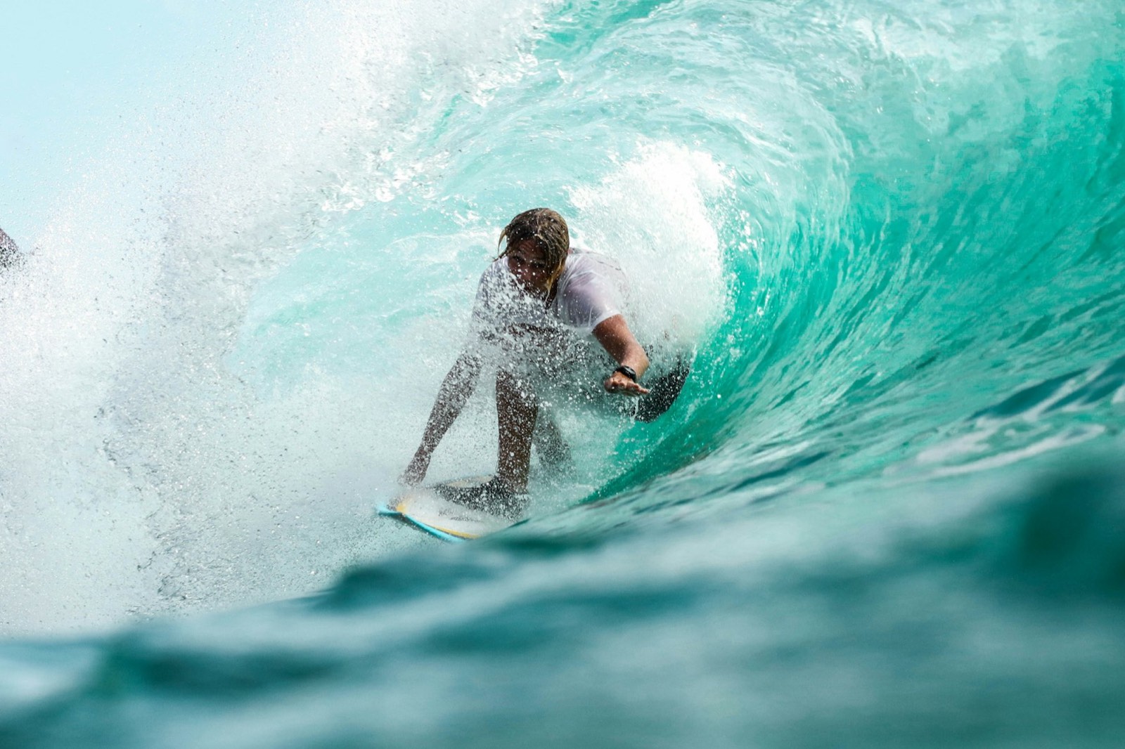 A surfer inside a breaking wave